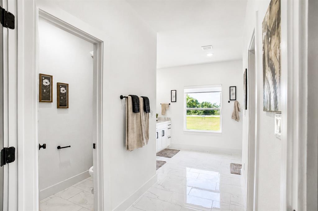 311 Dobbs Trail Springtown, TX 76082 - Photo 25 of 33 a bathroom with a tub shower and a window