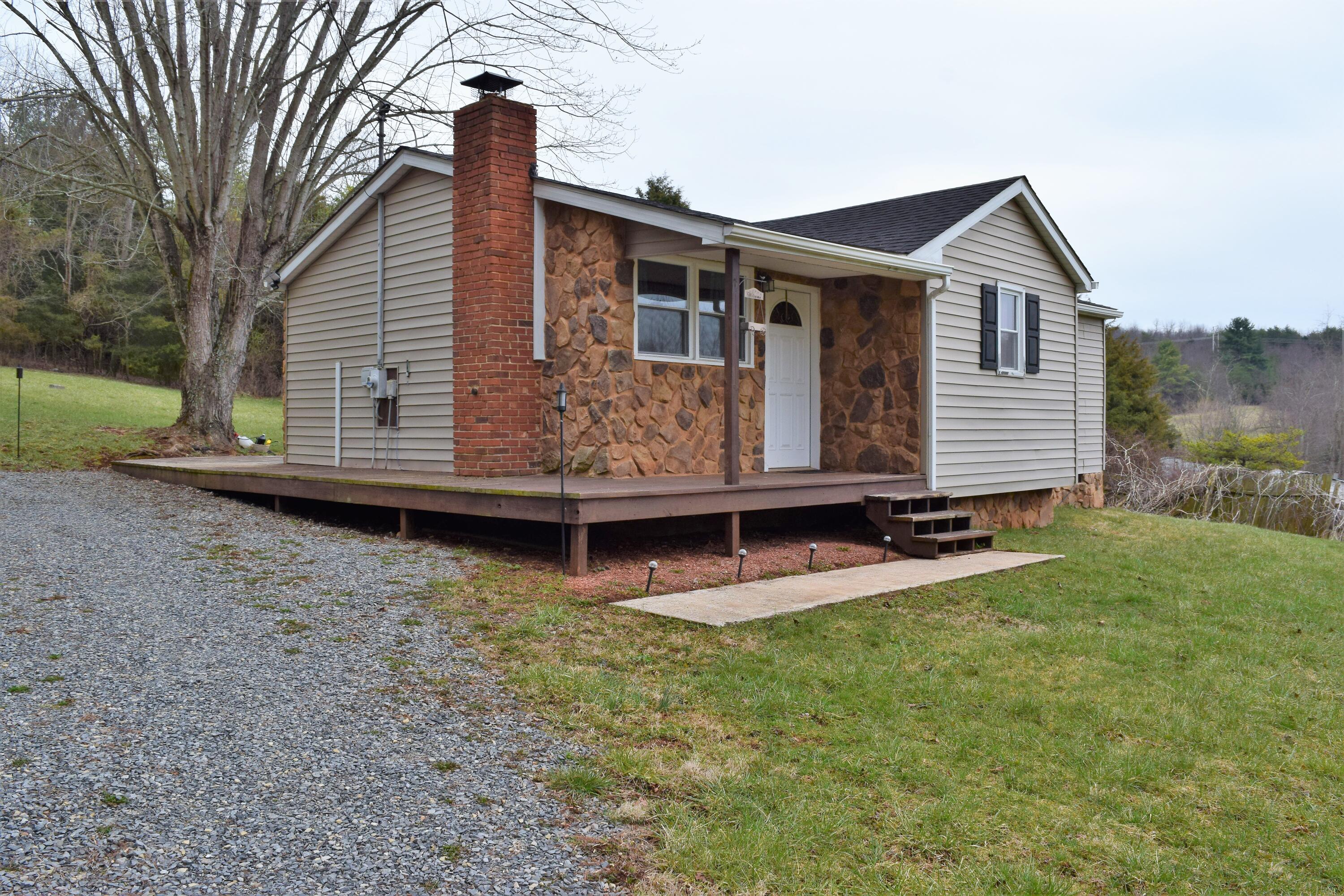 206 Gardner Road Barren Springs, VA 24313 - Photo 4 of 16 a front view of a house with a yard and porch