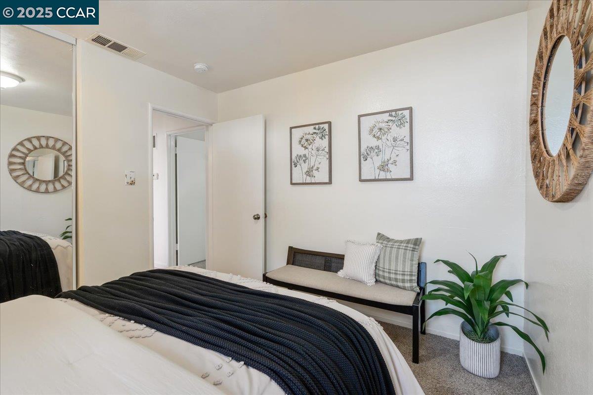 725 Del Norte Street Vallejo, CA 94591 - Photo 15 of 25 a bedroom that has a bed and paintings on the wall