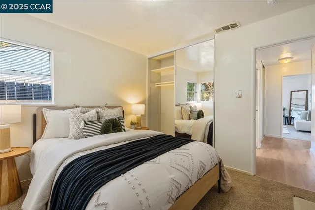 a bedroom with a bed and a mirror