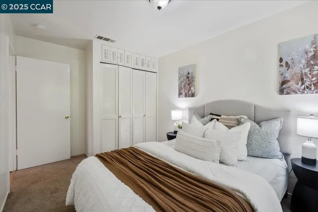 a bedroom with a bed and wall painting