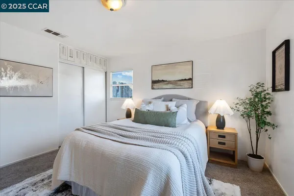 a bedroom with a bed and a potted plant