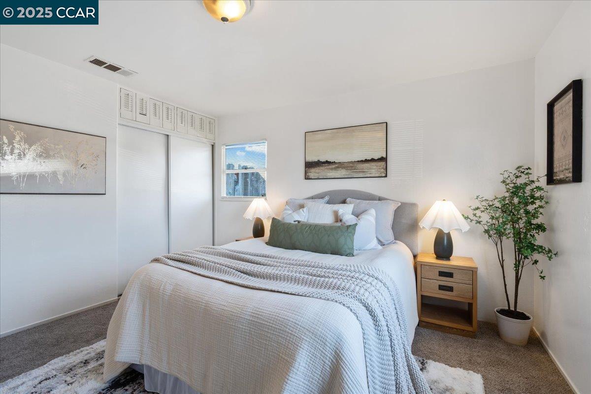 725 Del Norte Street Vallejo, CA 94591 - Photo 19 of 25 a bedroom with a bed and a potted plant