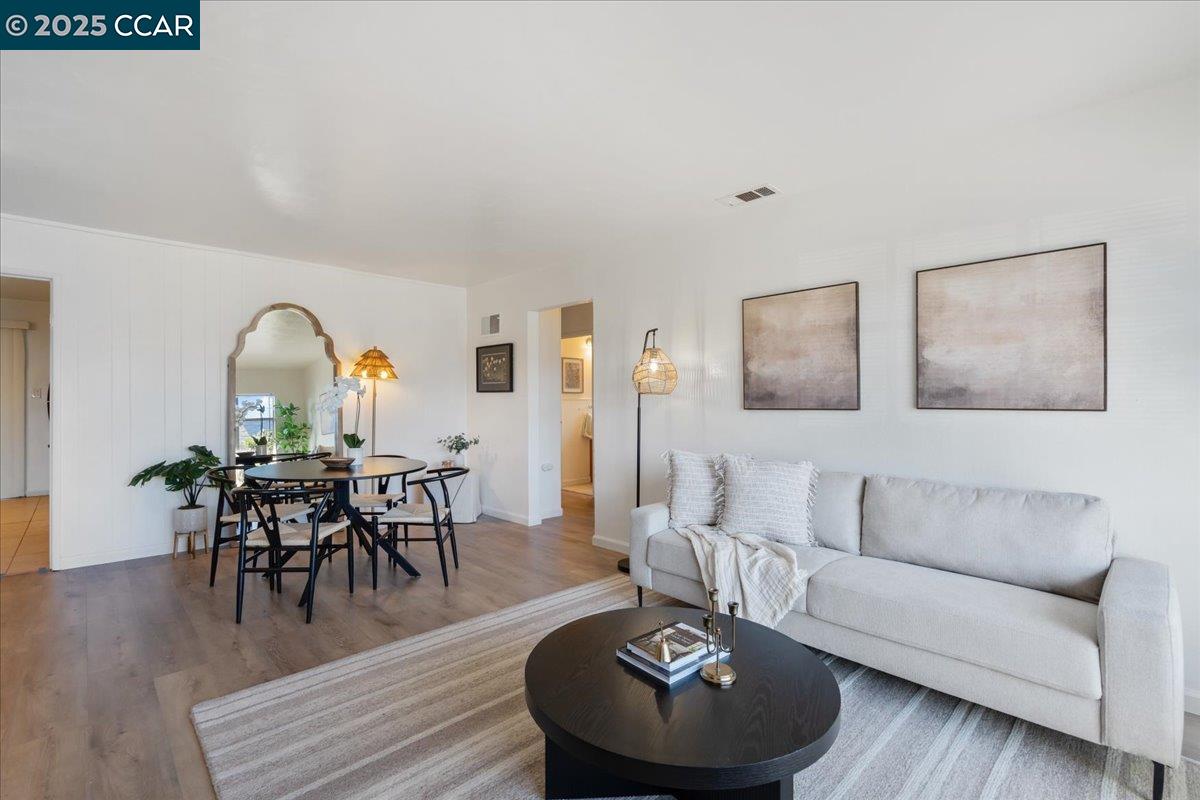 725 Del Norte Street Vallejo, CA 94591 - Photo 5 of 25 a living room with furniture a dining table and wooden floor