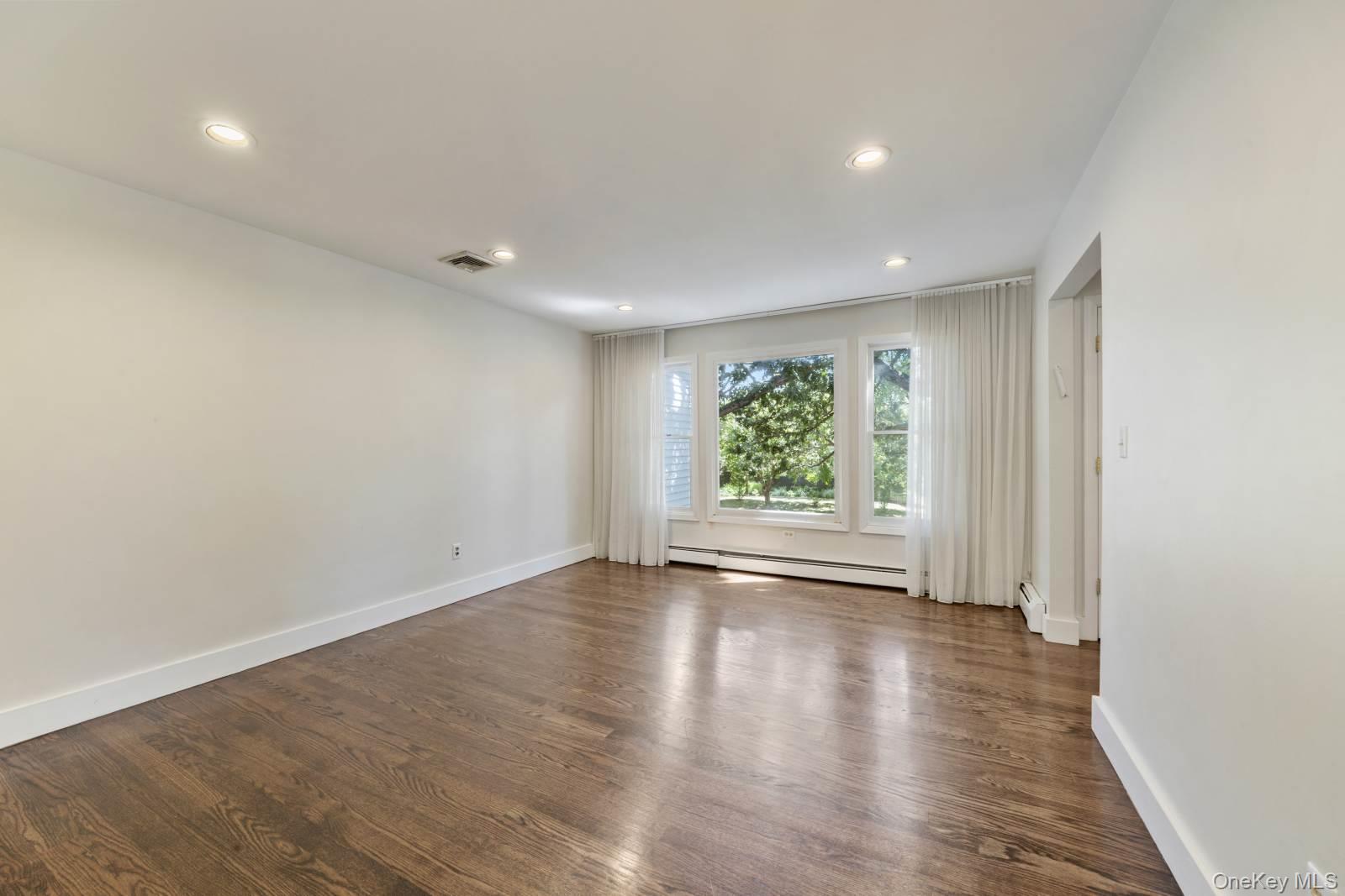 10 Demarest Road Spring Valley, NY 10977 - Photo 8 of 39 an empty room with wooden floor and window