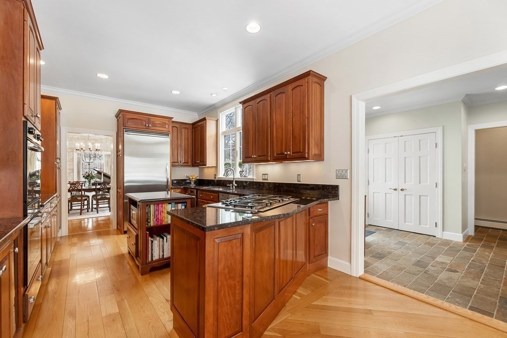 853 Strawberry Hill Road Concord, MA 01742 - Photo 11 of 41 a kitchen with stainless steel appliances granite countertop a stove top oven a sink dishwasher and cabinets with wooden floor