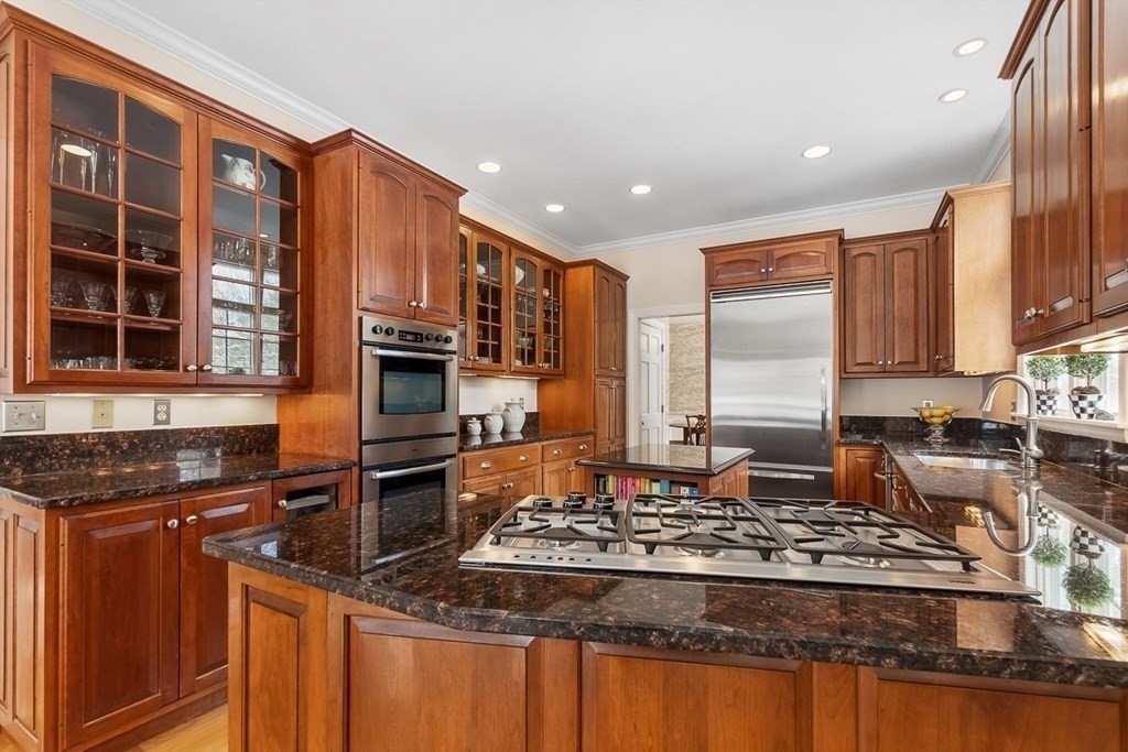 853 Strawberry Hill Road Concord, MA 01742 - Photo 12 of 41 a kitchen with kitchen island granite countertop a stove and cabinets