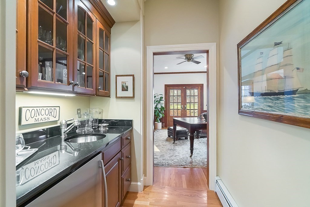 853 Strawberry Hill Road Concord, MA 01742 - Photo 19 of 41 a kitchen with stainless steel appliances granite countertop a stove and a wooden cabinets