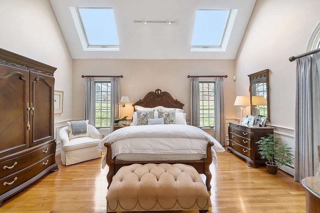 853 Strawberry Hill Road Concord, MA 01742 - Photo 21 of 41 a bedroom with a bed and wooden floor