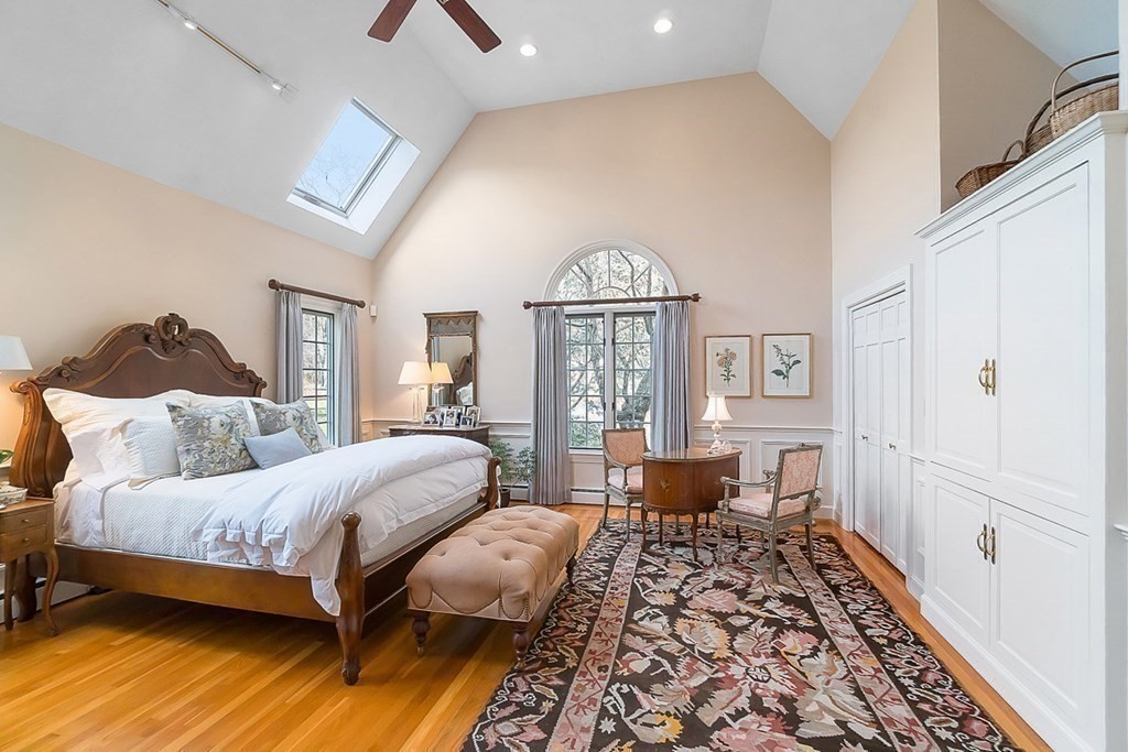 853 Strawberry Hill Road Concord, MA 01742 - Photo 22 of 41 a bedroom with a bed and wooden floor