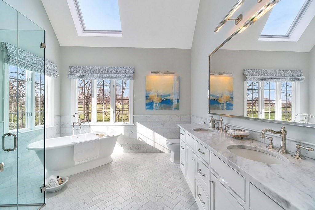853 Strawberry Hill Road Concord, MA 01742 - Photo 24 of 41 a spacious bathroom with a double vanity sink a mirror and a bathtub