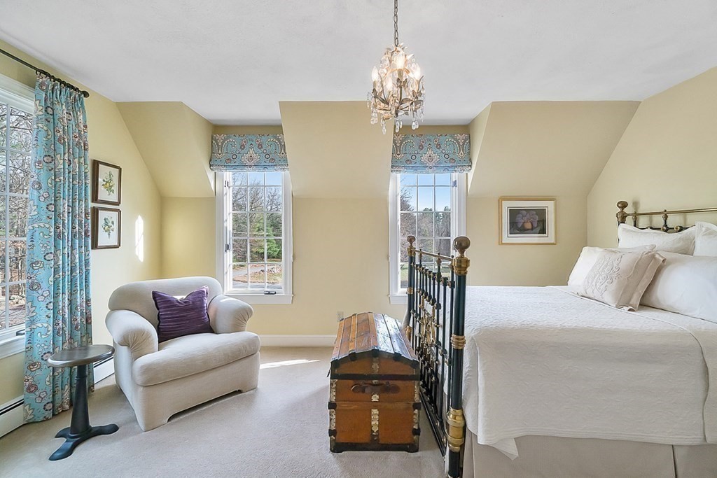 853 Strawberry Hill Road Concord, MA 01742 - Photo 29 of 41 a living room with furniture and a chandelier