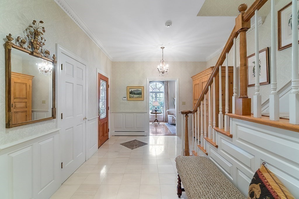 853 Strawberry Hill Road Concord, MA 01742 - Photo 5 of 41 a view of an entryway with wooden floor and a livingroom