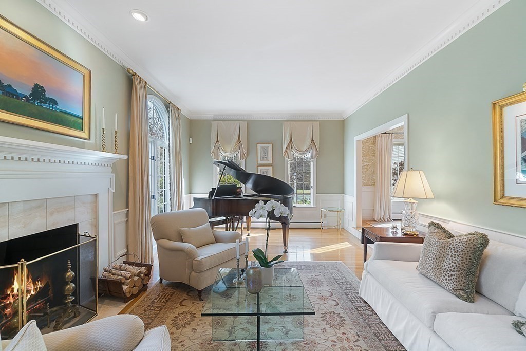 853 Strawberry Hill Road Concord, MA 01742 - Photo 8 of 41 a living room with furniture a fireplace and a large window