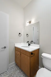 a bathroom with a sink toilet and mirror