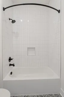 a bathroom with a shower and a bath tub