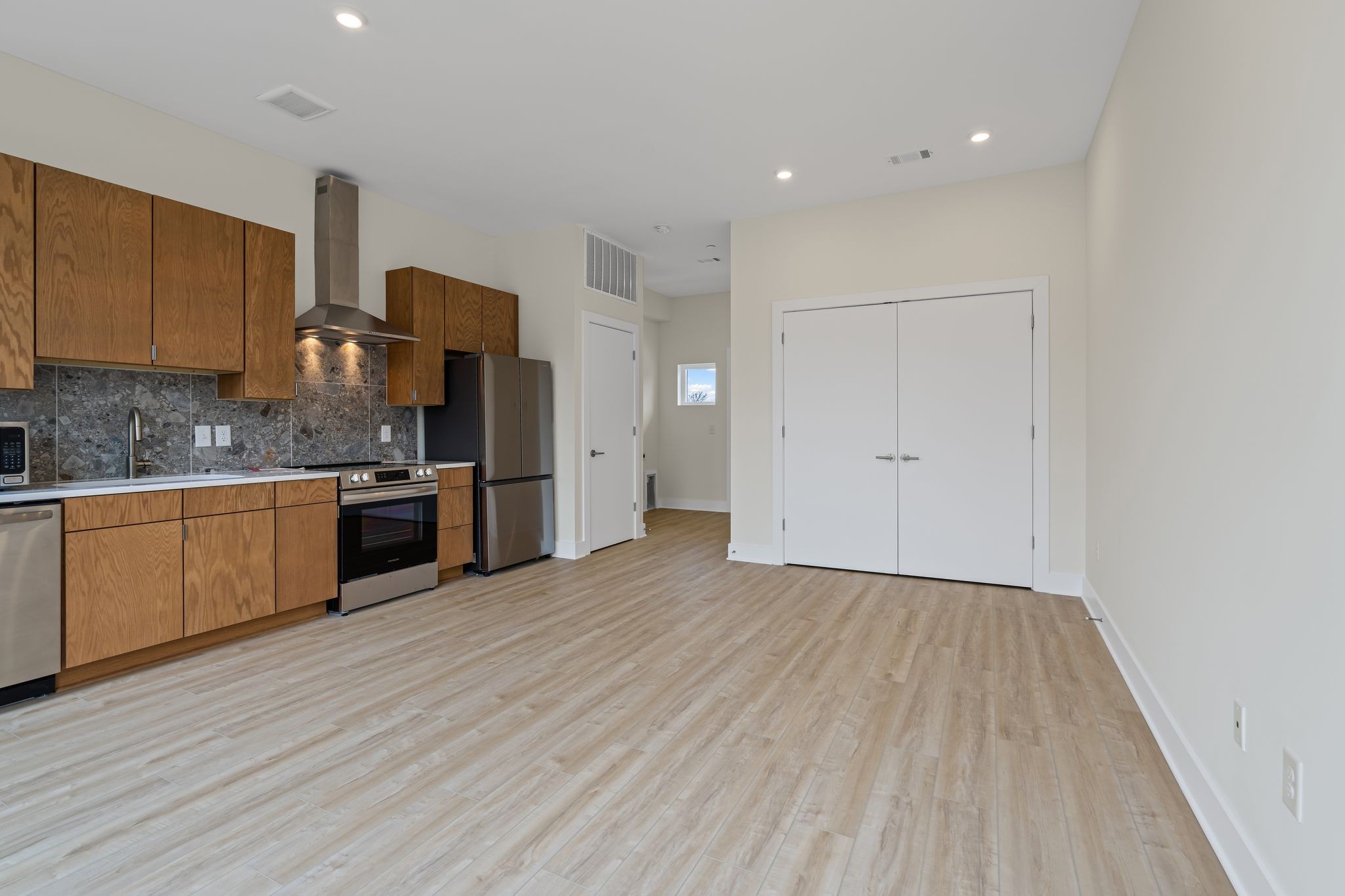 1310 Lischey Avenue, Unit 305 Nashville, TN 37207 - Photo 9 of 20 a kitchen with wooden floors and white cabinets