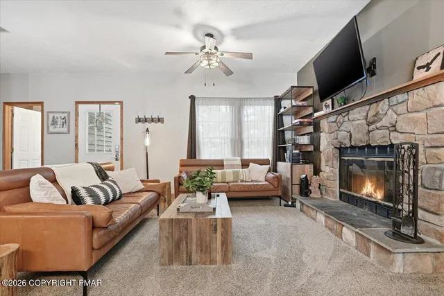 a living room with furniture and a fireplace