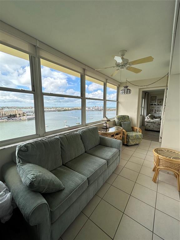 4775 Cove Circle, Unit 1202 Madeira Beach, FL 33708 - Photo 12 of 32 a living room with furniture and a large window