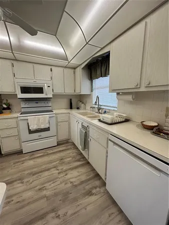 a spacious bedroom with a bed and a chandelier