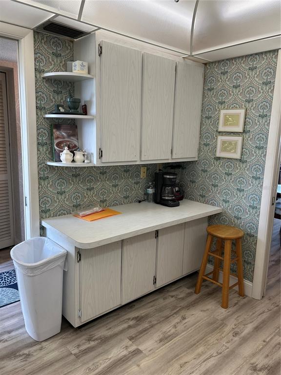 4775 Cove Circle, Unit 1202 Madeira Beach, FL 33708 - Photo 21 of 32 a room with a sink and a wooden floor