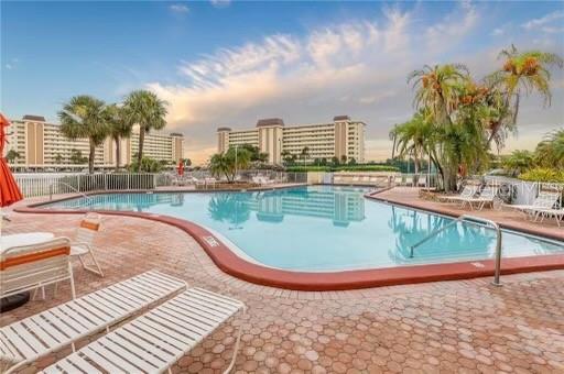 4775 Cove Circle, Unit 1202 Madeira Beach, FL 33708 - Photo 28 of 32 a view of a swimming pool with a terrace