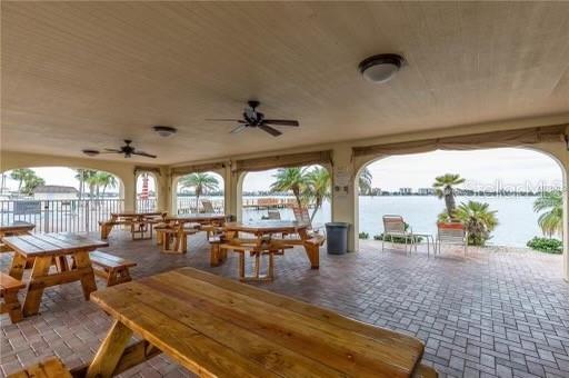 4775 Cove Circle, Unit 1202 Madeira Beach, FL 33708 - Photo 30 of 32 a living room with furniture and a large window