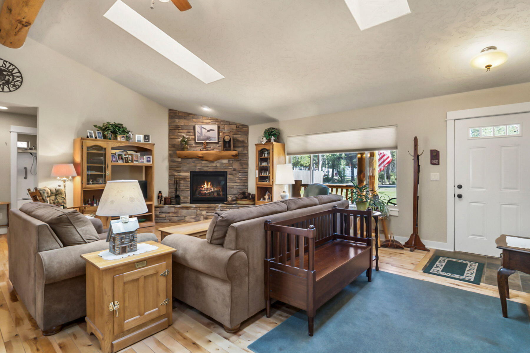 17048 Norwalk Road Bend, OR 97707 - Photo 15 of 36 a living room with fireplace furniture and a flat screen tv