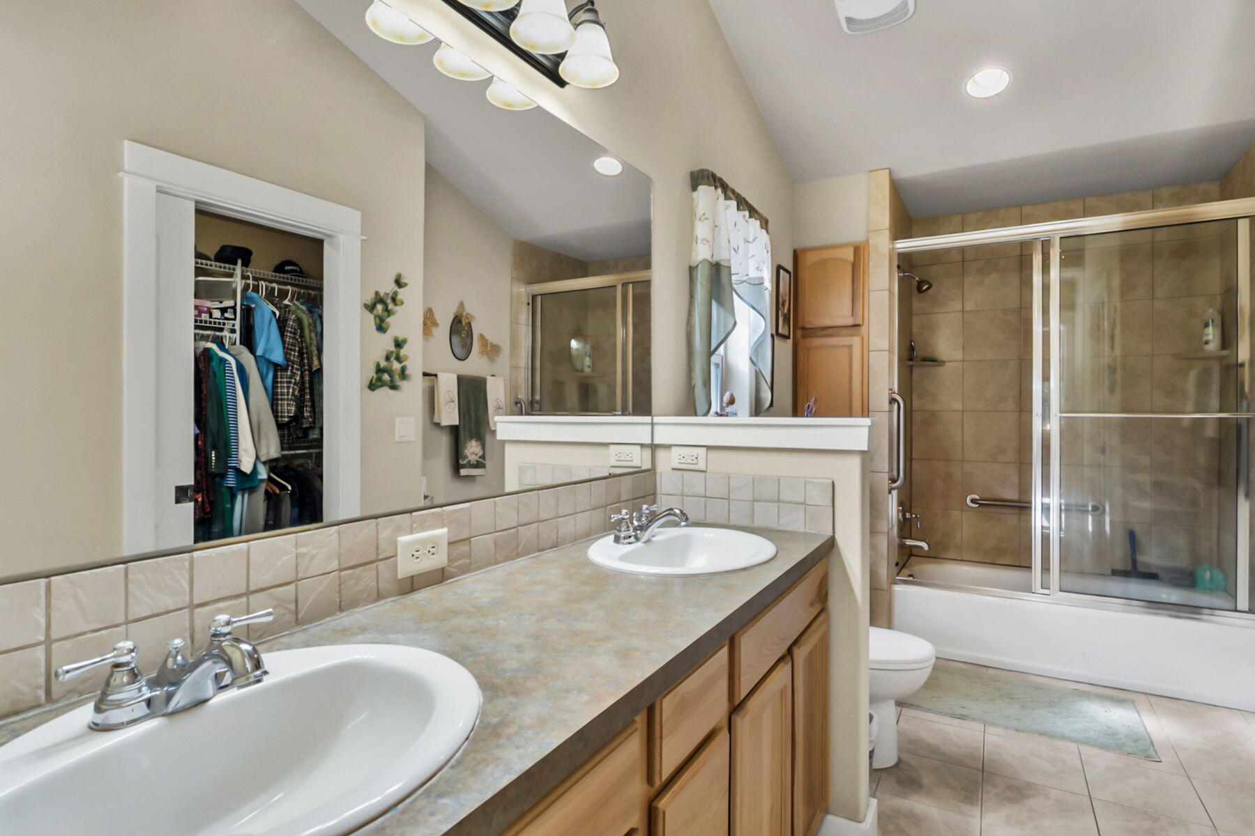 17048 Norwalk Road Bend, OR 97707 - Photo 17 of 36 a bathroom with a granite countertop sink a mirror and a shower