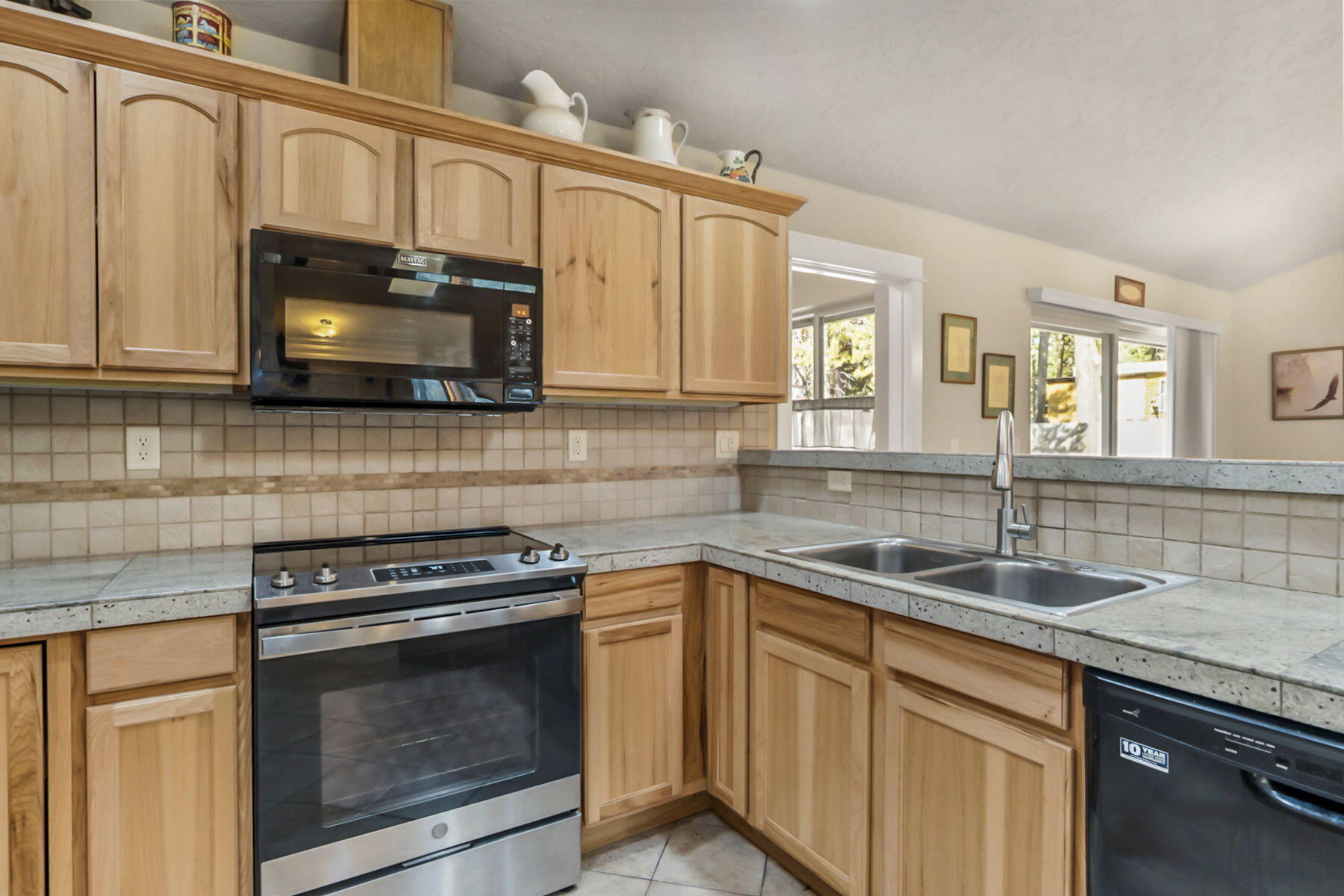17048 Norwalk Road Bend, OR 97707 - Photo 7 of 36 a kitchen with granite countertop a sink stainless steel appliances and cabinets