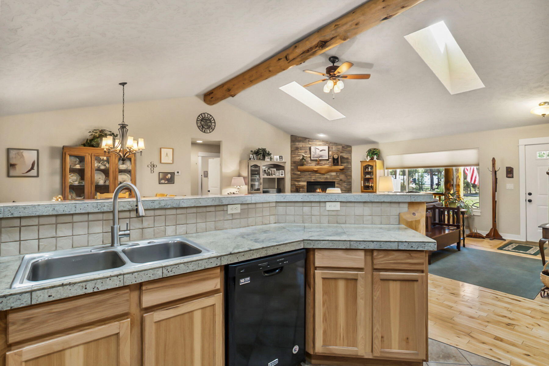 17048 Norwalk Road Bend, OR 97707 - Photo 10 of 36 a kitchen with stainless steel appliances granite countertop a sink a oven and a wooden cabinets