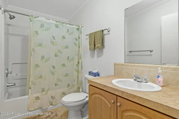 a white bath tub sitting next to a white sink