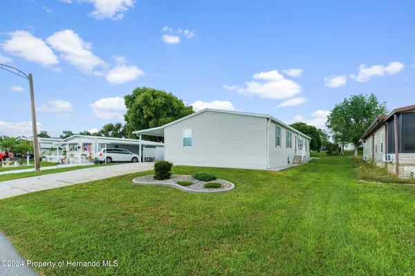 a backyard of a house with plants and a garden