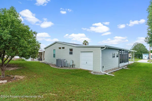 a view of an house with backyard space and garden