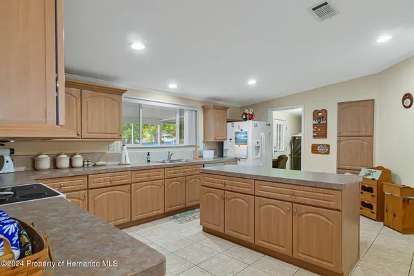 a kitchen with granite countertop a stove top oven sink and cabinets