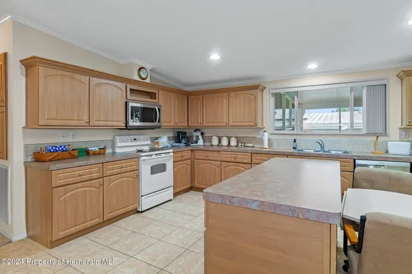 a kitchen with a dining table chairs and microwave