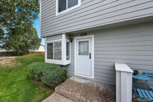 an empty room with a fireplace and window