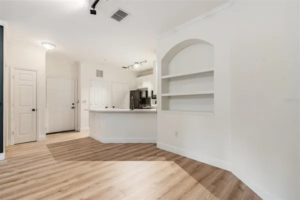 a view of a room with wooden floor and a sink