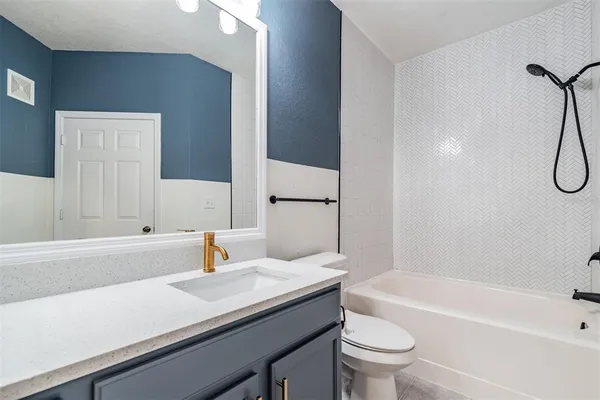 a bathroom with a bath tub with a shower