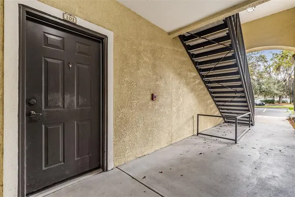 a view of a door and bench in the room