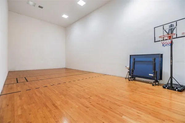 a living room with furniture large window and wooden floor