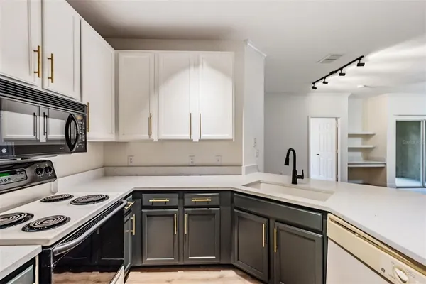 a kitchen with a sink stove and microwave