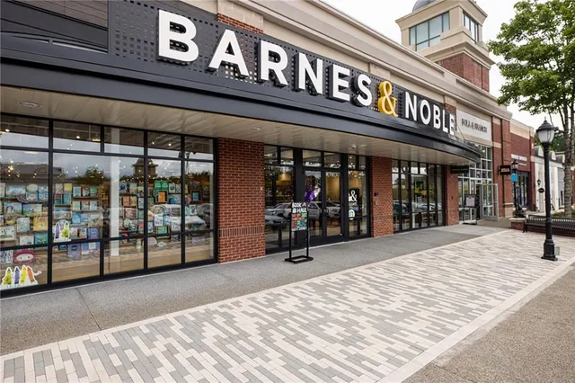a view of a patio with dining table and chairs and potted plants