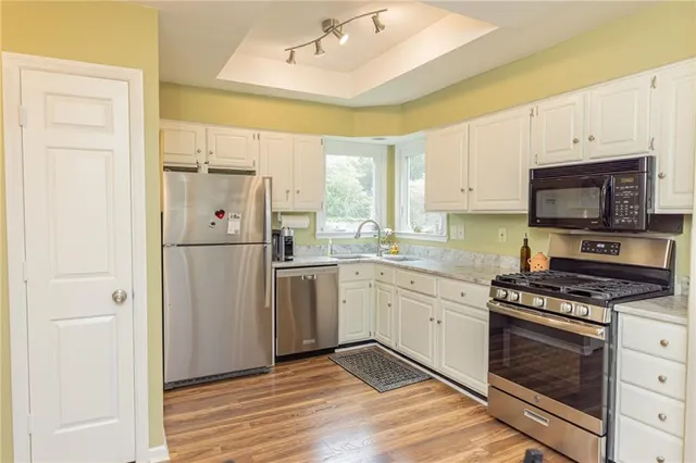 a kitchen with a refrigerator a stove a microwave and cabinets
