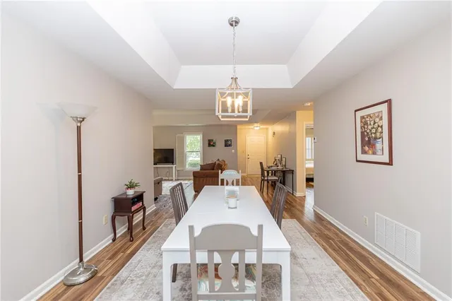 a view of a dining room with furniture wooden floor and chandelier