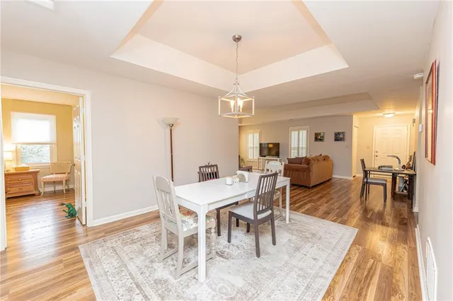 a living room with furniture a wooden floor and next to a window