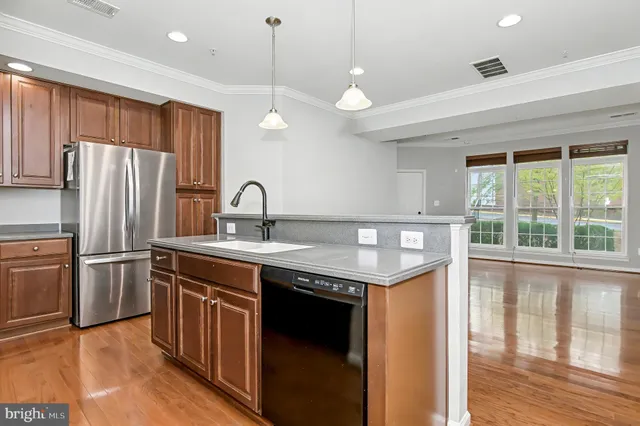 a kitchen with stainless steel appliances a stove a microwave and a refrigerator