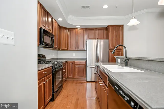 a kitchen that has a sink a window and a table in it