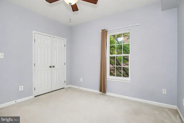 an empty room with chandelier fan