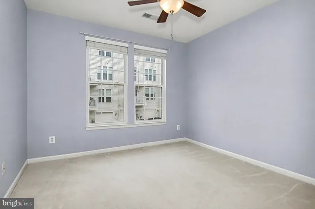 a bedroom with a bed couches and a flat screen tv